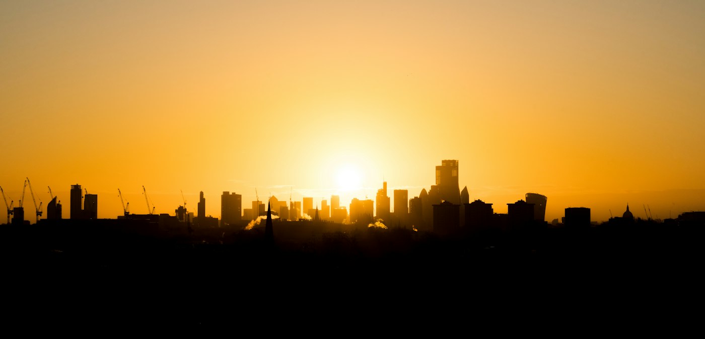Sunrise over a city skyline, representing Design Tribe's vision